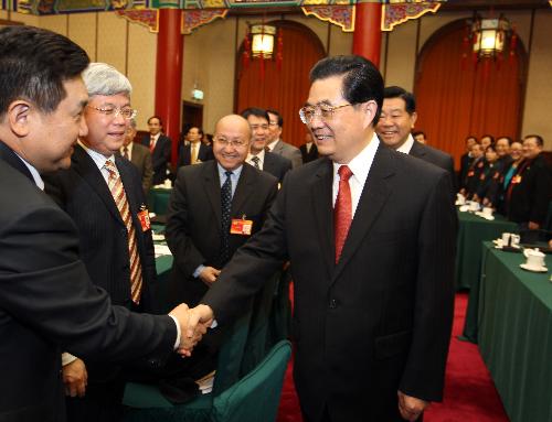 Chinese President Hu Jintao (R, front), who is also General Secretary of the Central Committee of the Communist Party of China (CPC) and Chairman of the Central Military Commission, visits and joins a panel discussion of members of the 11th National Committee of the Chinese People's Political Consultative Conference (CPPCC) from the China National Democratic Construction Association and the All-China Federation of Industry and Commerce in Beijing, capital of China, March 4, 2010. 