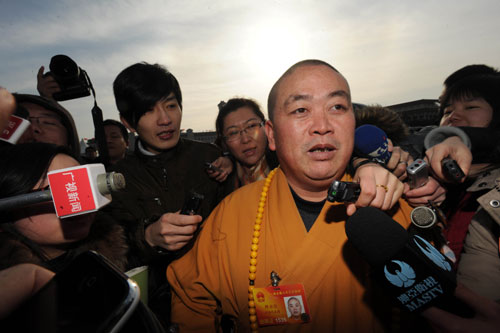 Shi Yongxin, deputy to the Third Session of the 11th National People&apos;s Congress (NPC) and also abbot of Shaolin temple, is interviewed prior the opening meeting of the Third Session of the 11th NPC outside the Great Hall of the People in Beijing, capital of China, March 5, 2010.