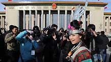 A deputy to the Third Session of the 11th National People's Congress (NPC) walks to the Great Hall of the People in Beijing, capital of China, March 5, 2010.