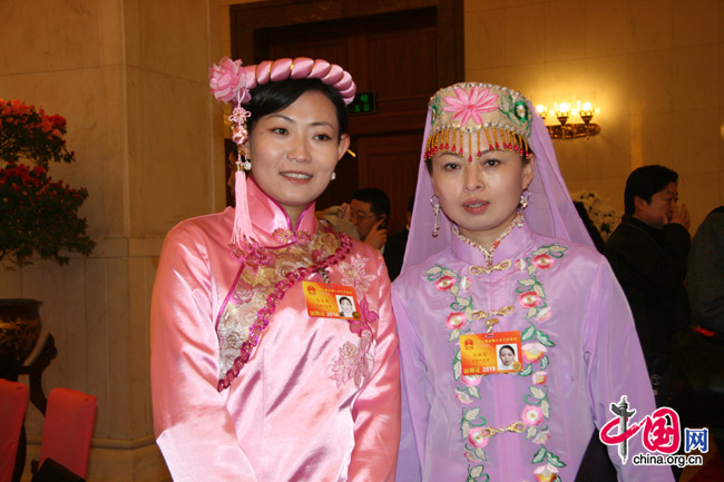 NPC deputies, from the Dongxiang (left) and Bonan (right) peoples, attend the National People&apos;s Congress at the Great Hall of the People in Beijing, March 5, 2010. 