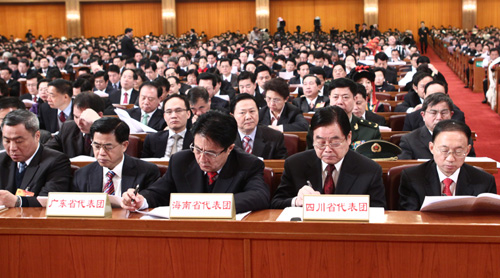 Delegations to the Third Session of the 11th National People&apos;s Congress (NPC) from south China&apos;s Guangdong Province, Hainan Province and southwest China&apos;s Sichuan Province (L to R) attend the opening meeting of the Third Session of the 11th NPC at the Great Hall of the People in Beijing, capital of China, March 5, 2010.