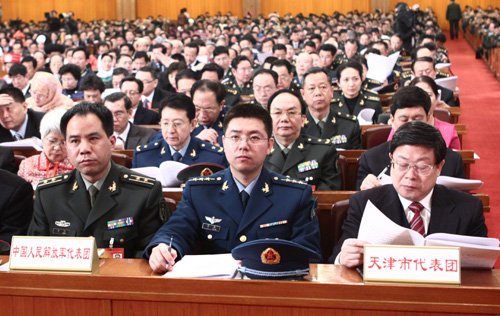 Delegations to the Third Session of the 11th National People&apos;s Congress (NPC) from north China&apos;s Tianjin Municipality (R) and Chinese People&apos;s Liberation Army attend the opening meeting of the Third Session of the 11th NPC at the Great Hall of the People in Beijing, capital of China, March 5, 2010.