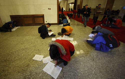 Journalists work prior to the opening meeting of the Third Session of the 11th National People's Congress (NPC) at the Great Hall of the People in Beijing, capital of China, March 5, 2010. 