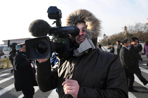 A foreign journalist works prior to the opening meeting of the Third Session of the 11th National People's Congress (NPC) at the Tiananmen Square in Beijing, capital of China, March 5, 2010.