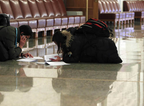 Journalists work prior to the opening meeting of the Third Session of the 11th National People's Congress (NPC) at the Great Hall of the People in Beijing, capital of China, March 5, 2010. 