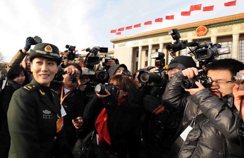 Journalists interview Tan Jing, a deputy to the Third Session of the 11th National People's Congress (NPC) prior to the opening meeting of the Third Session of the 11th NPC outside the Great Hall of the People in Beijing, capital of China, March 5, 2010.