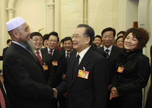 Chinese Premier Wen Jiabao (C) joins a panel discussion with deputies to the Third Session of the 11th National People&apos;s Congress (NPC) from west China&apos;s Gansu Province, in Beijing, capital of China, March 6, 2010.