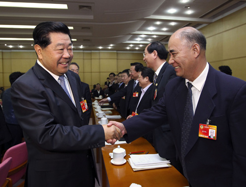 Jia Qinglin (L, front), chairman of the National Committee of the Chinese People&apos;s Political Consultative Conference (CPPCC), joins a panel discussion with CPPCC members from the Chinese Peasants&apos; and Workers&apos; Democratic Party and Jiu San (September 3rd) Society in Beijing, capital of China, March 6, 2010.