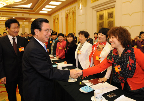 He Guoqiang (L, front), member of the Standing Committee of the Political Bureau of the Communist Party of China (CPC) Central Committee, also head of the CPC Central Commission for Discipline Inspection, joins a panel discussion with deputies to the Third Session of the 11th National People&apos;s Congress (NPC) from central China’s Hunan Province, in Beijing, capital of China, March 6, 2010.