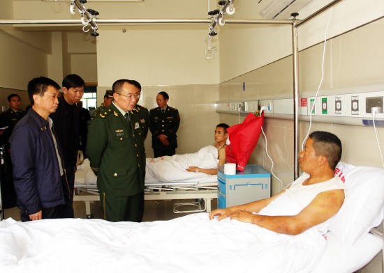 Two injured paramilitary policemen during a truck crash accident receive treatment at a hospital in Baoshan, South China's Yunnan Province, March 7, 2010. 