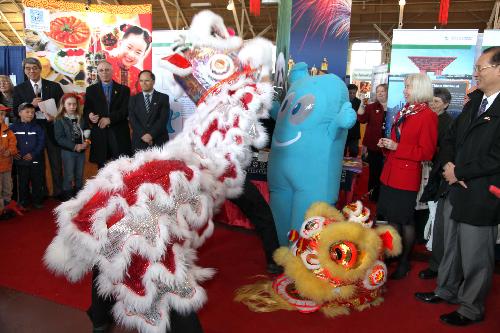 Visitors watch the performance during a tourism photo exhibition featuring the 2010 Shanghai World Expo, in Ottawa, Canada, March 7, 2010.