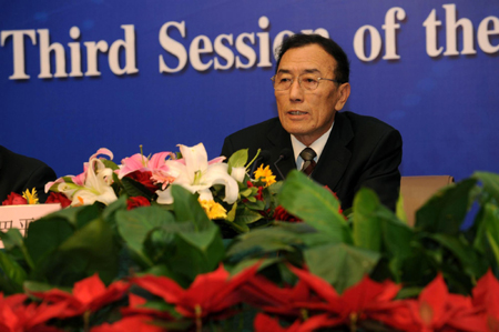 Qiangba Puncog, chairman of the standing committee of the Tibet autonomous regional people's congress, speaks at a press conference on the sidelines of an ongoing session of the National People's Congress, the top legislature, in Beijing, March 7, 2010.