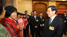 Chinese President Hu Jintao talks with deputies to the Third Session of the 11th National People's Congress (NPC) from Tianjin Municipality, in Beijing, capital of China, March 8, 2010.