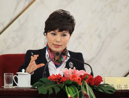 Li Ruiying, member of the 11th National Committee of the Chinese People's Political Consultative Conference (CPPCC), answers questions by journalists during a news conference held by the Third Session of the 11th National Committee of the CPPCC on the 2010 Shanghai World Expo in Beijing, capital of China, March 8, 2010.