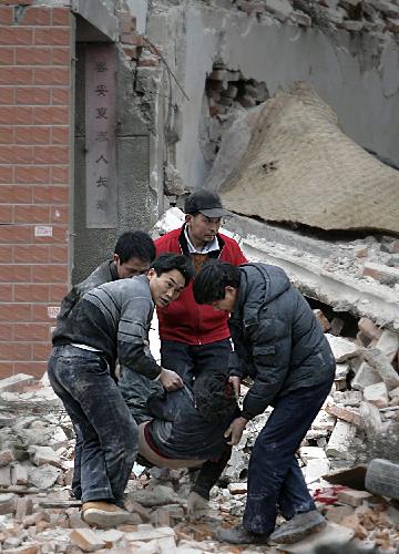 Rescuers save a buried worker from the debris after a collapse of floor slabs at a demolition site in Wuhan, capital of central China&apos;s Hubei Province, March 8, 2010. 
