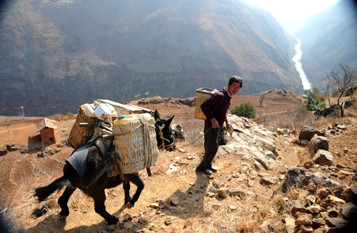 Villagers drive mule down the mountain to fetch water in Huize County of Qujing City, southwest China's Yunnan Province, on March 7, 2010. 