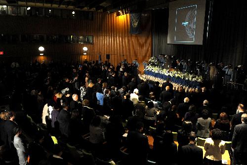 Participants stand in silence during the ceremony commemorating the 101 UN personnel that perished in Haiti's Jan. 12 earthquake at the UN headquarters in New York, the United States, March 9, 2010