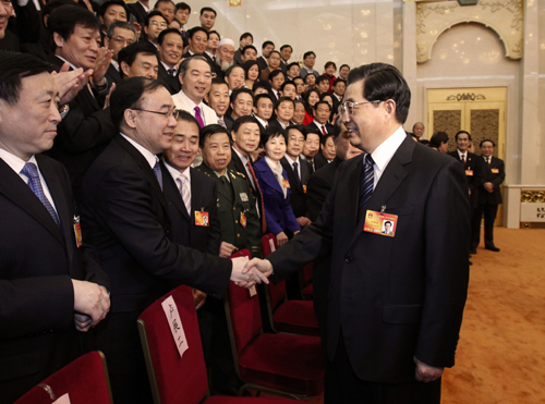 Chinese President Hu Jintao (R, front) joins a panel discussion with deputies to the Third Session of the 11th National People&apos;s Congress from central China&apos;s Henan Province in Beijing, China, March 10, 2010.
