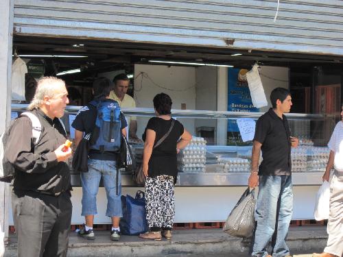 Local residents buy eggs at a reopened egg shop in the quake-striken city of Concepcion, Chile, March 9, 2010.