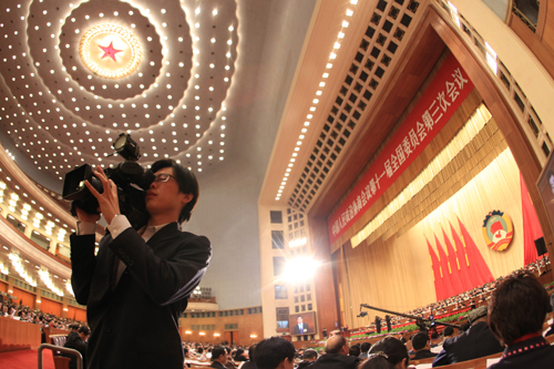 A journalist works during the fourth plenary meeting of the Third Session of the 11th National Committee of the Chinese People&apos;s Political Consultative Conference (CPPCC) at the Great Hall of the People in Beijing, capital of China, March 10, 2010. 