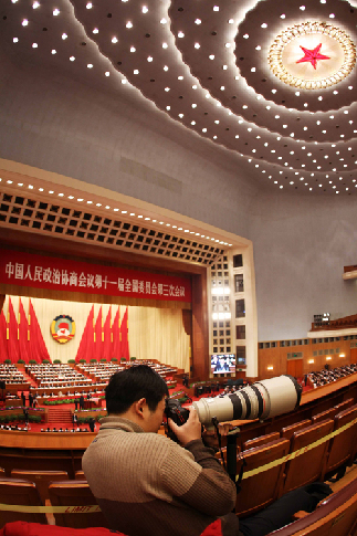 A journalist works during the fourth plenary meeting of the Third Session of the 11th National Committee of the Chinese People&apos;s Political Consultative Conference (CPPCC) at the Great Hall of the People in Beijing, capital of China, March 10, 2010.