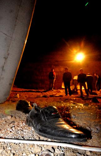 Photo taken on March 10, 2010 show a shoe of a passenger at the site of a bus accident near Shanshulin Bridge between Longli and Guiyang, capital of southwest China's Guizhou Province. 