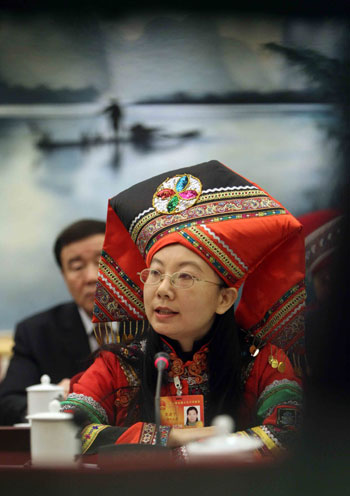 Qin Jianning, deputy of Zhuang ethnic group to the Third Session of the National People&apos;s Congress (NPC) from southwest China&apos;s Guangxi Zhuang Autonomous Region, speaks during a panel discussion on the work report of the Standing Committee of the NPC in Beijing, China, March 10, 2010.