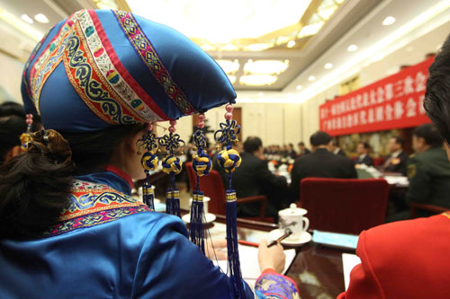 A deputy of minority ethnic group to the Third Session of the National People&apos;s Congress (NPC) from southwest China&apos;s Guangxi Zhuang Autonomous Region attends a panel discussion on the work report of the Standing Committee of the NPC in Beijing, China, March 10, 2010.