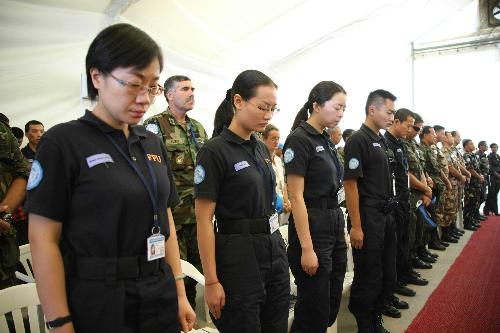 Members of Chinese peacekeeping anti-riot police team mourn in a ceremony commemorating the UN personnel that perished in Haiti&apos;s Jan. 12 earthquake in Port-au-Prince, capital of Haiti, March 9, 2010.