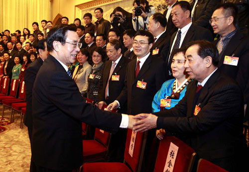 He Guoqiang (L, front), member of the Standing Committee of the Political Bureau of the Communist Party of China (CPC) Central Committee, joins a panel discussion with deputies to the Third Session of the 11th National People&apos;s Congress (NPC) from northeast China&apos;s Jilin Province in Beijing, capital of China, March 11, 2010.