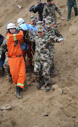 Rescuers carry survivor Cao Lele at the site of landslide at Shuanghuyu Village in Zizhou County, northwest China's Shaanxi Province, on March 12, 2010. Twenty-year-old Cao Lele and his 17-year-old sister Cao Yanyan were rescued early Friday after being buried 54 hours following the landslide, which occurred early Wednesday. The landslide left 26 people dead among the total of 44 trapped.