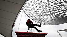 Steeplejacks in charge of LED maintenance of the Sun Valley at the Expo Axis are in training, in Shanghai, east China, March 7, 2010.