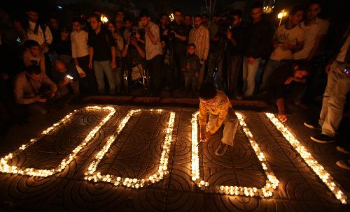 Palestinians light candles forming the number 1000 during a rally marking 1000 days of the Israeli blockade on the Gaza Strip, in Gaza City on March 11, 2010.