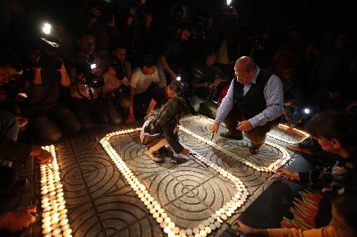 Palestinians light candles forming the number 1000 during a rally marking 1000 days of the Israeli blockade on the Gaza Strip, in Gaza City on March 11, 2010.