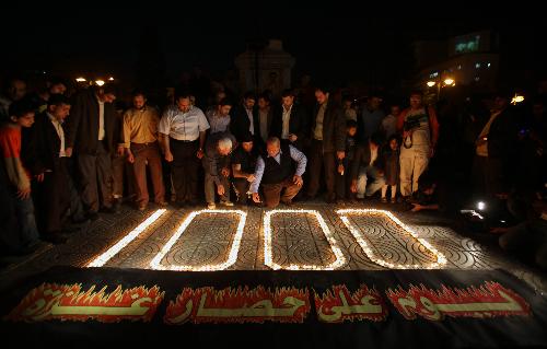 Palestinians light candles forming the number 1000 during a rally marking 1000 days of the Israeli blockade on the Gaza Strip, in Gaza City on March 11, 2010.