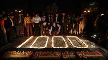 Palestinians light candles forming the number 1000 during a rally marking 1000 days of the Israeli blockade on the Gaza Strip, in Gaza City on March 11, 2010.