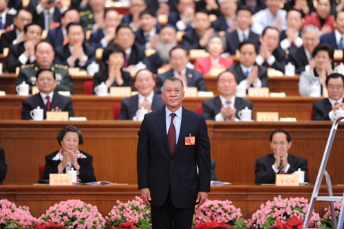 Edmund Ho Hau Wah (front), former chief executive of China&apos;s Macao Special Administrative Region (SAR), stands on the rostrum after being elected vice chairman of the 11th National Committee of the Chinese People&apos;s Political Consultative Conference (CPPCC) at the closing ceremony of the Third Session of the 11th CPPCC National Committee at the Great Hall of the People in Beijing, capital of China, March 13, 2010. 