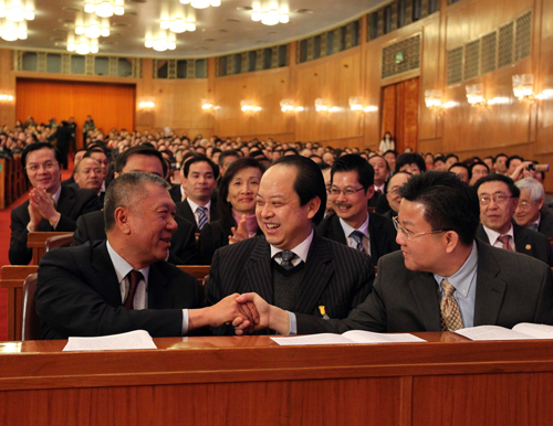 Edmund Ho Hau Wah (L, front) is congratulated by members of the 11th National Committee of the Chinese People&apos;s Political Consultative Conference (CPPCC) after being elected vice chairman of the National Committee of the Chinese People&apos;s Political Consultative Conference (CPPCC) at the closing ceremony of the Third Session of the 11th CPPCC National Committee at the Great Hall of the People in Beijing, capital of China, March 13, 2010.