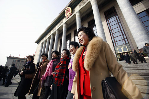 CPPCC National Committee members walk out of the Great Hall of the People in Beijing after the closing ceremony of the CPPCC annual session, March 13, 2010. 