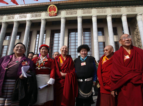 Members of the 11th National Committee of the Chinese People's Political Consultative Conference (CPPCC) leave the Great Hall of the People in Beijing, capital of China, March 13, 2010.