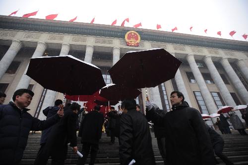 Staff members wait to welcome the deputies to the Third Session of the 11th National People's Congress (NPC) prior to the closing meeting of the Third Session of the 11th NPC at the Great Hall of the People in Beijing, China, March 14, 2010.