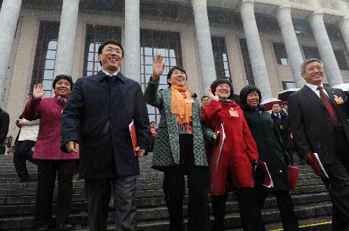 Deputies to the Third Session of the 11th National People's Congress (NPC) leave the Great Hall of the People after the closing meeting of the Third Session of the 11th NPC in Beijing, China, March 14, 2010. 