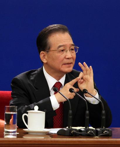 Chinese Premier Wen Jiabao answers questions during a press conference after the closing meeting of the Third Session of the 11th National People's Congress (NPC) at the Great Hall of the People in Beijing, capital of China, March 14, 2010.