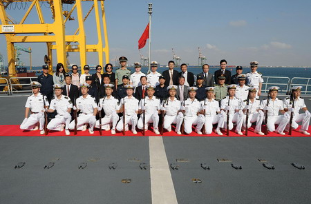 Staff members of the Chinese embassy in Yemen and fleet officers pose for a photo on the Chinese navy supply ship Qiandaohu at the Gulf of Aden near Yemen on March 14, 2010.