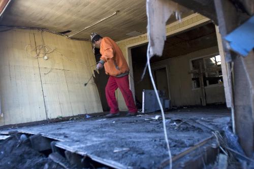 A man removes debris at home in Talcahuano, Chile, on March 15, 2010.