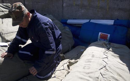 A soldier distributes Chinese aid materials in Talcahuano, Chile, on March 15, 2010. 