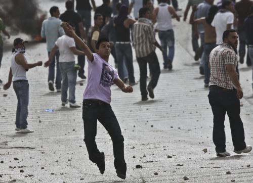 Palestinian protesters hurl stones towards Israeli troops during clashes at Atara Checkpoint in the north of the West Bank city of Ramallah, on March 15, 2010. 