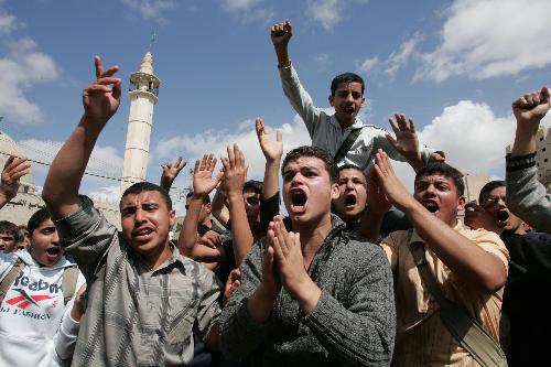 Palestinian youths chant slogans during a rally against Israel's consecration of a synagogue in Jerusalem's Old City, in Khan Yunis in southern Gaza strip on March 16, 2010.