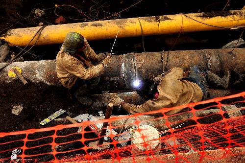 Workers repair a section of under-ground pipes in Talcahuano, Chile, on March 16, 2010. Preliminary estimate shows Chile needs US$30 billion for repair following the 8.8-magnitude earthquake on Feb. 27, President Sebastian Pinera said Tuesday. 