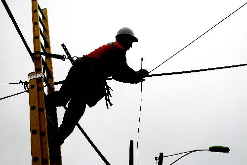 A worker repairs electric facilities in Talcahuano, Chile, on March 16, 2010. Preliminary estimate shows Chile needs US$30 billion for repair following the 8.8-magnitude earthquake on Feb. 27, President Sebastian Pinera said Tuesday.